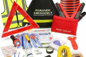 Comprehensive roadside emergency kit including jumper cables, reflective triangle, first aid kit, flashlight, and safety vest.